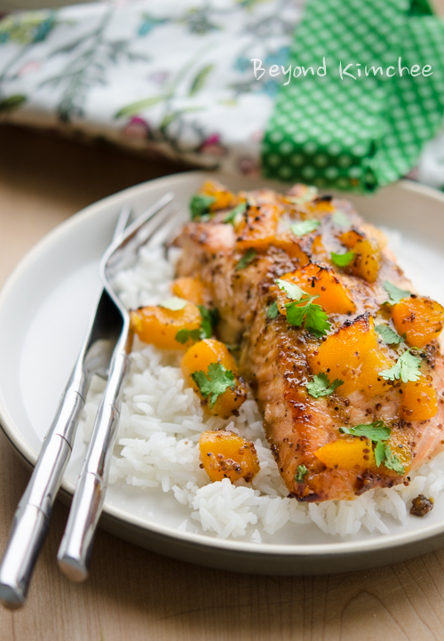 Salmon fillet is baked with mustard and peach glaze and served with rice.