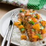 Salmon fillet is baked with mustard and peach glaze and served with rice.