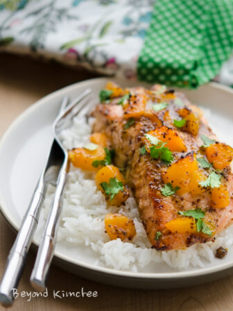 Salmon fillet is baked with mustard and peach glaze and served with rice.