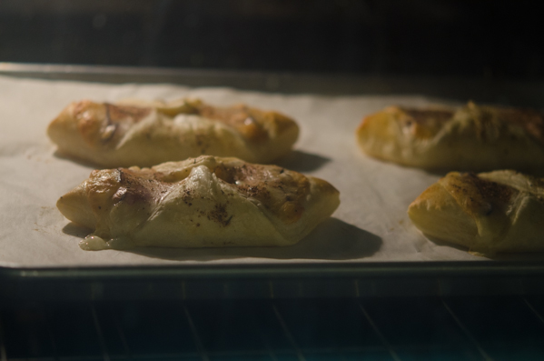Ham and cheese puff pastries are baking in the oven.