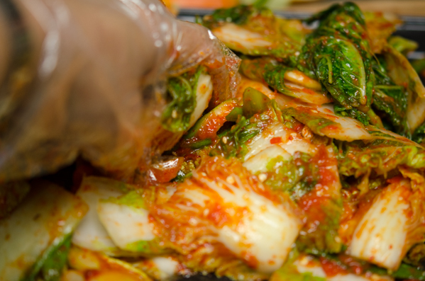 Hand tossing is a good method to mix cabbage and kimchi filling