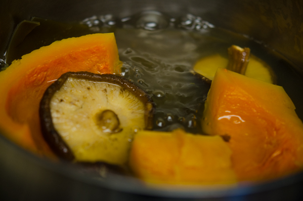 Vegetable stock made with pumpkin and mushroom for vegan kimchi is simmering.