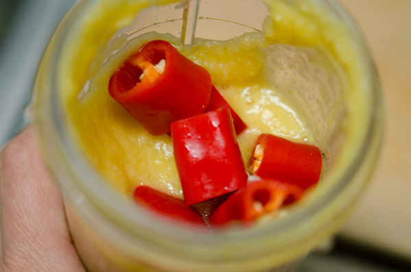 Sliced fresh red chili is added to persimmon onion puree.