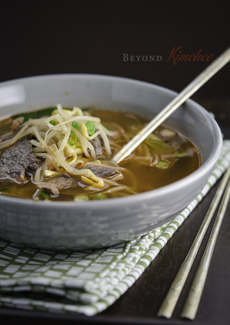 Beef and Bean Sprout Soup is served in a bowl with a spoon.