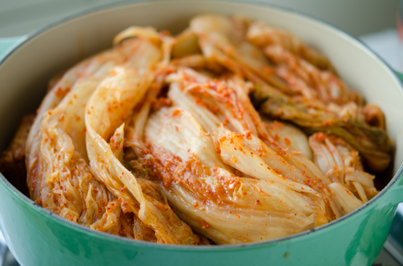 A few heads of old Mugeunji cabbage kimchi are placed on top of pork ribs.