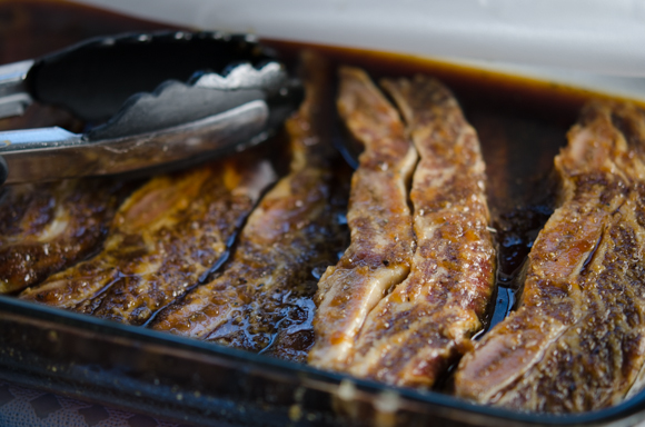 Marinated beef short ribs are resting in a room temperature.