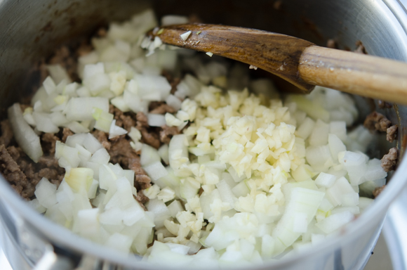 Chopped onion and garlic are added to browned ground beef.