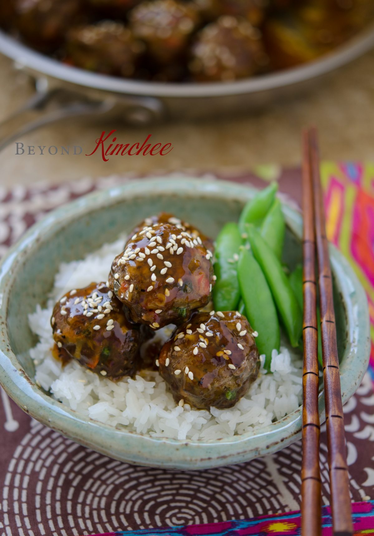Luscious beef meatballs are served over rice and snow peas. 