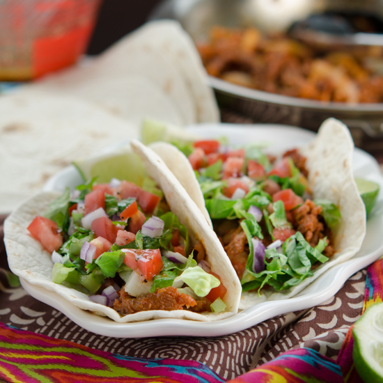 Spicy Korean pork tacos on a plate.