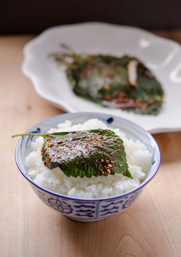 A seasoned and steamed perilla leaf is served over rice.