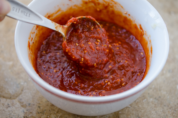 Homemade Korean gochujang sauce shows its bold red color.