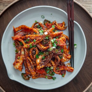 Korean spicy squid stir-fry (ojingeo bokkeum) in a serving dish.