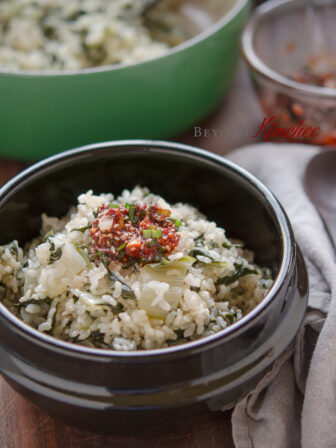 Brown rice is cooked with Swiss chard together and serve with chili topping sauce