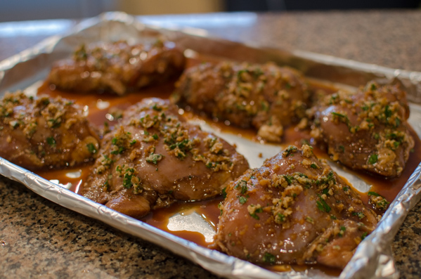 Balsamic soy sauce marinated chicken thighs on a baking sheet.
