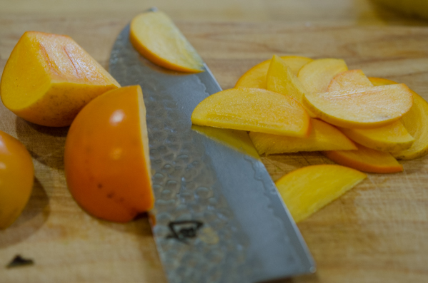 persimmon being cut into slices