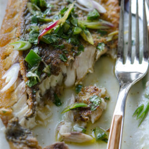 Mexican style grilled fish is topped with cilantro green onion sauce
