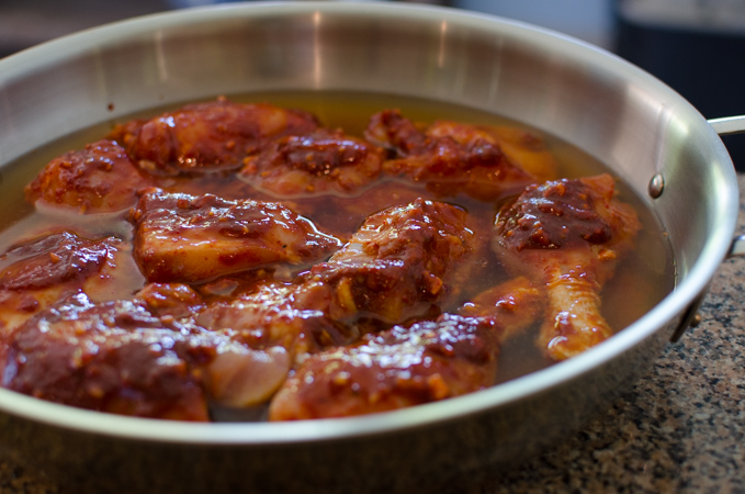 Chicken pieces are coated with spicy paste and barely simmered in a stock.
