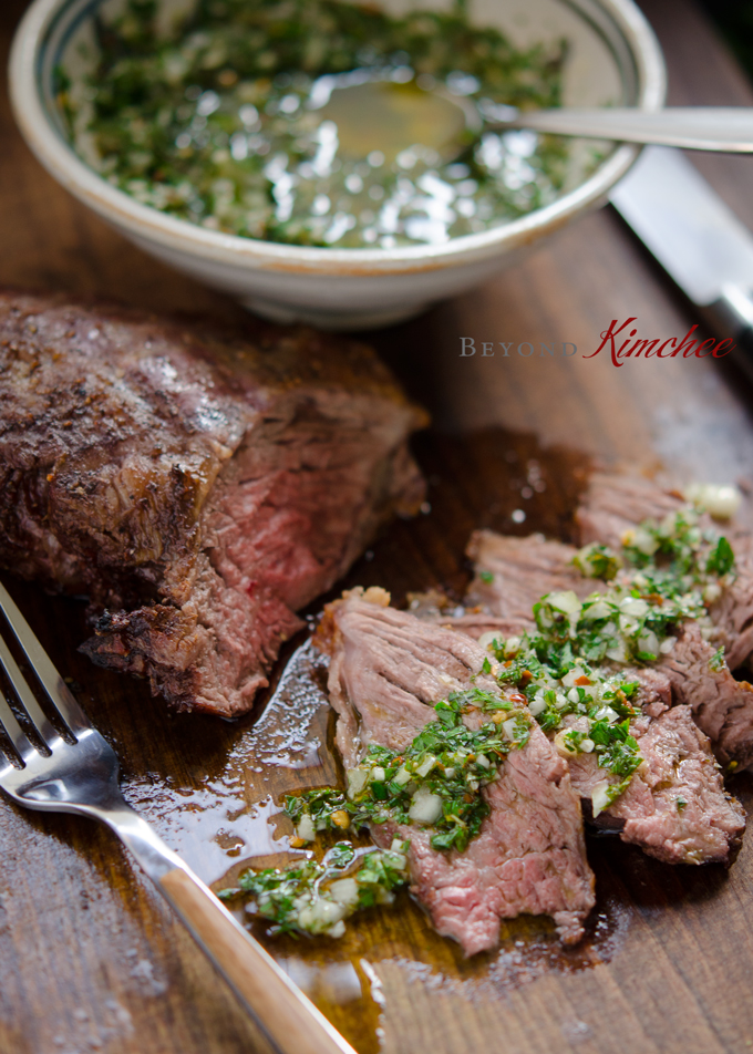 Beef steak is drizzled with Argentine chimichurri sauce