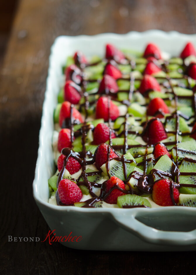 Strawberry Kiwi Tiramisu is drizzled with chocolate syrup for a festive holiday look.