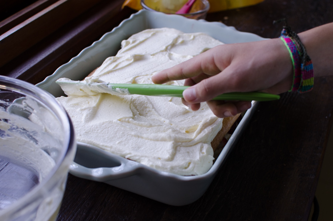 Mascarpone cheese mixture covers the ladyfinger cookies