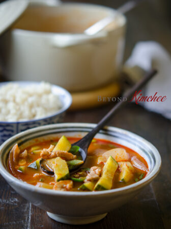 Pork and zucchini are simmered in spicy broth in this Korean stew