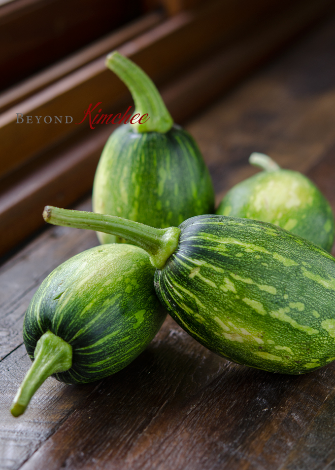 Korean zucchini is slightly oval in shape and has a distinctive green pattern on the skin