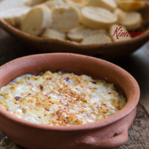 Warm hearts of palm dip is served with baguette slices.