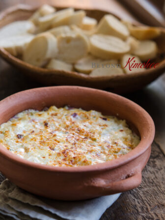 Warm hearts of palm dip is served with baguette slices.