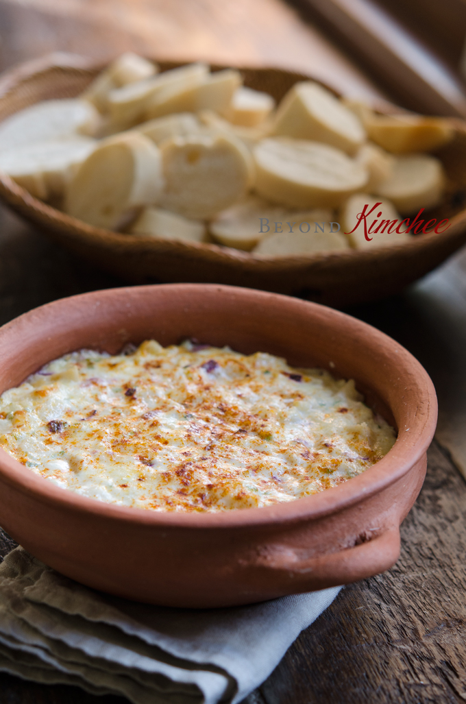 Warm hearts of palm dip is served with baguette slices.