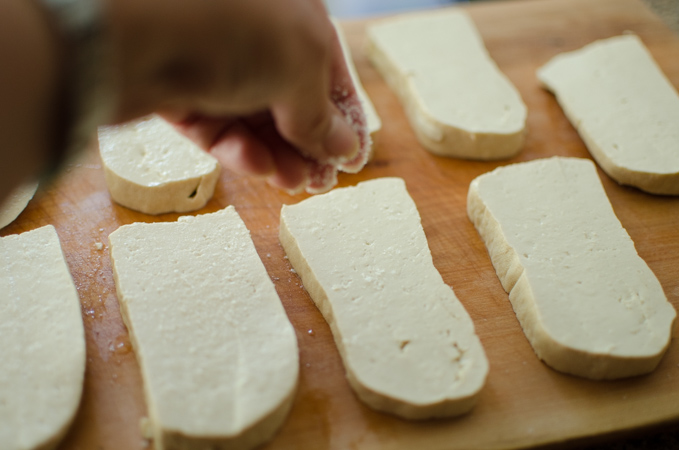 Tofu slices are lightly seasoned with salt.