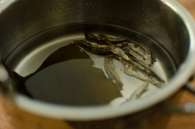 Anchovy sea kelp stock is simmered in a pan.