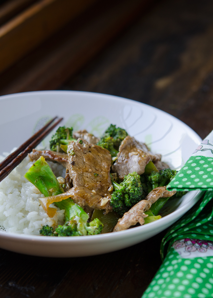 Quick stir-fried beef and fresh broccoli florets are serve with rice.