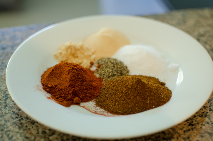 Various spices are collected to make homemade dry rub for barbecue.