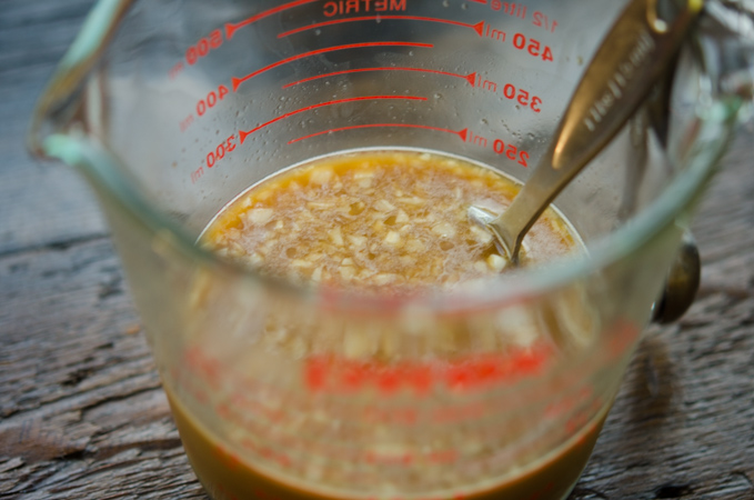 Beef stir-fry sauce ingredients are mixed in a glass measuring cup.