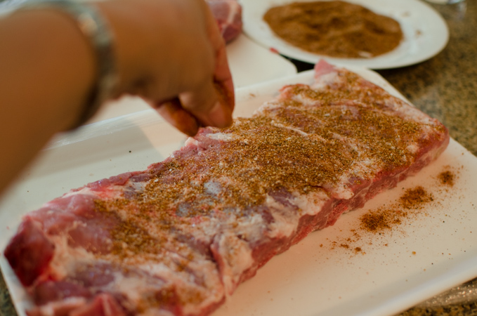 Sprinkle homemade dry rub to the pork ribs.