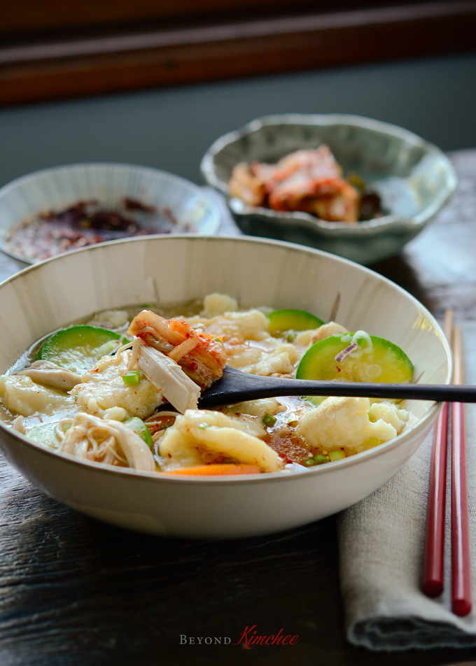 Korean Chicken and Potato Dumpling is hand torn noodle soup and served with kimchi.