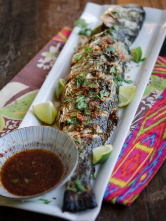Grilled Fish is served with Soy Lime Chili Sauce and lime wedges