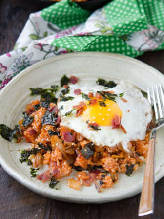 Bacon Kimchi Fried Rice is topped with a fried egg and seaweed.