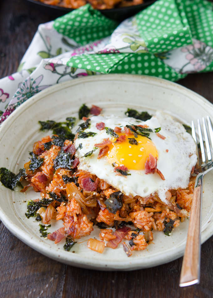 Kimchi Fried Rice made with crisp bacon and topped with a fried egg and seaweed.