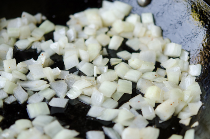 Chopped onions cooked soft in a skillet.