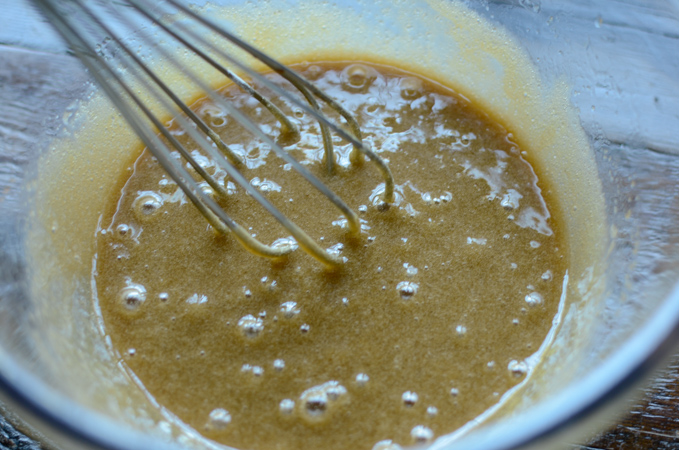 Wet ingredients are whisked together to make oat carrot bread.