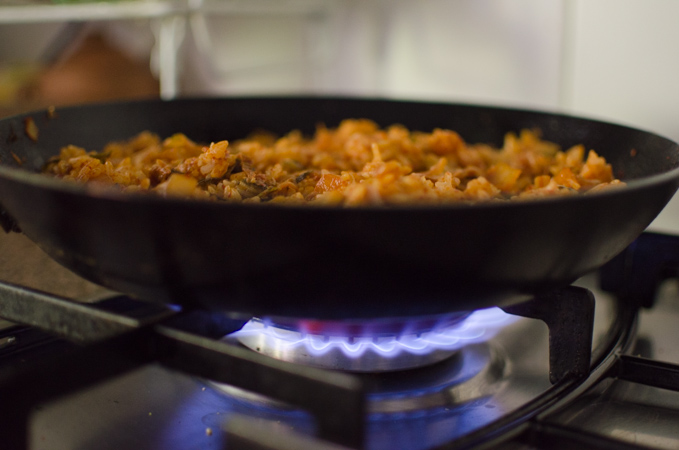 Making scorched rice (nurungji) over the heat for crispy bottom of kimchi fried rice with bacon.