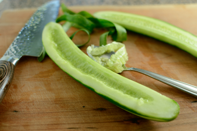 Cucumber is sliced in half lengthwise and seeded.