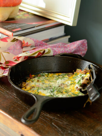 This no-bake vegetable frittata is cooked in an cast iron skillet.