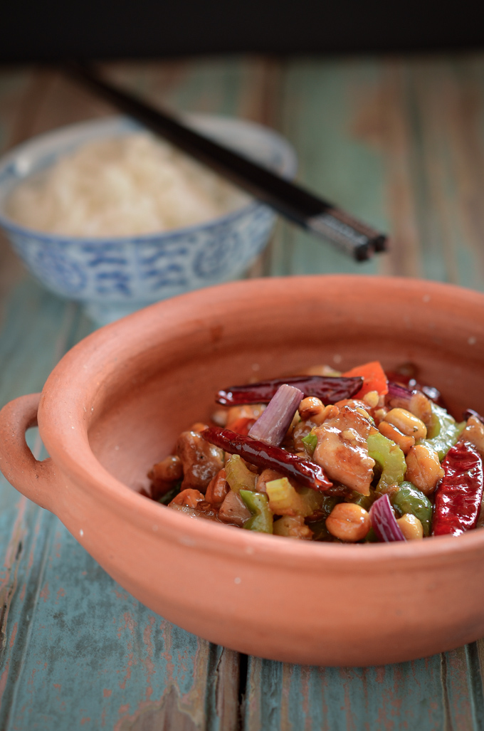 Chinese Kung Pao chicken and vegetable is served with rice.