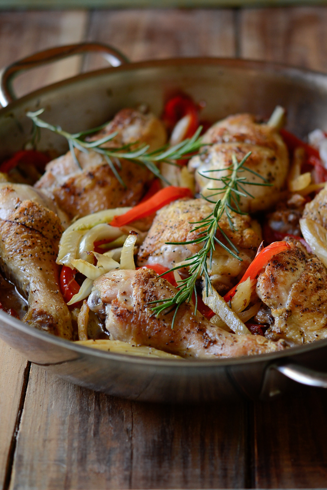 Chicken, fennel, red pepper, and onion are roasted in a pan