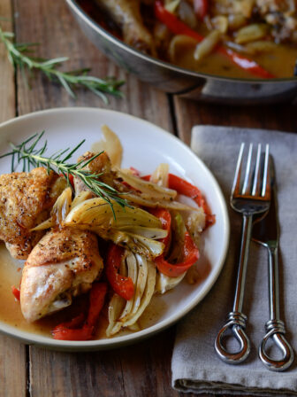 Chicken parts are roasted with fennel, pepper, onion and garnished with fresh rosemary.