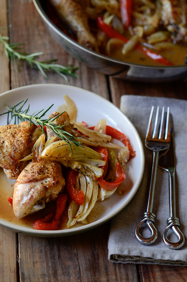 Chicken parts are roasted with fennel, pepper, onion and garnished with fresh rosemary.