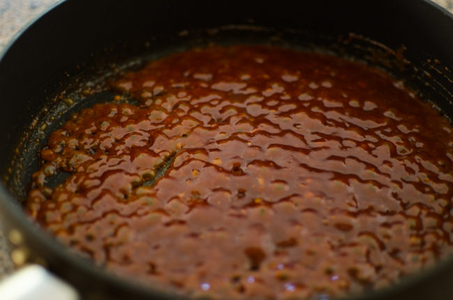 Sweet and savory gochujang sauce is boiling in a pan.