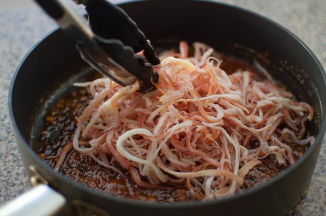 Moistened shredded squid strips are added to the gohujang sauce.